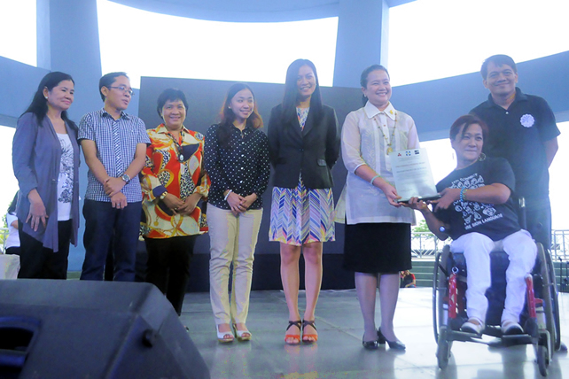 DOJ officials receive the PWD Friendly Website Plaque from NCDA Executive Director Carmen Zubiaga.